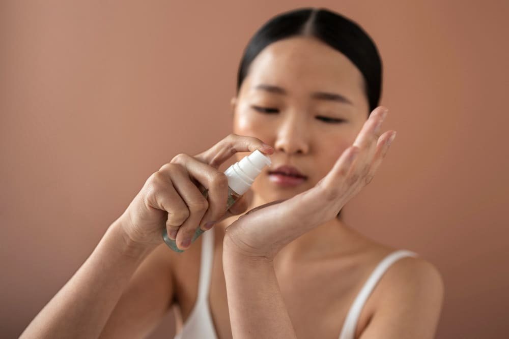 Applying moisturiser after shower as part of a gentle skincare routine for eczema and psoriasis.