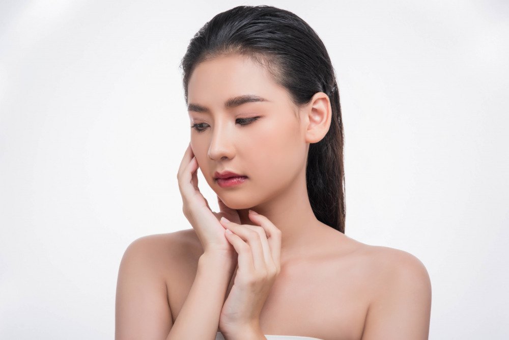 Woman with glowing, natural skin embracing holistic natural skincare 
